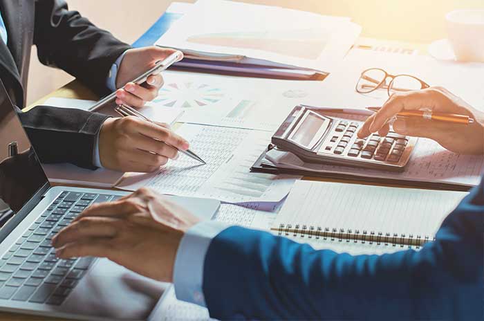 two people at desk reviewing the trust documents